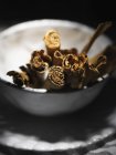Cinnamon sticks in white vintage bowl, close up shot — Stock Photo
