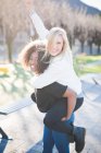 Two female friends having fun in park — Stock Photo