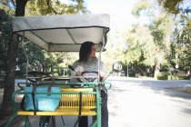 Mature woman sitting in golf buggy, looking away, Seville, Spain — Stock Photo