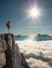 Climber looking out from peak emerging from fog in the Alps, Bettmeralp, Valais, Switzerland — Stock Photo