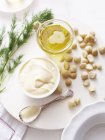 Still life of macadamia oil, mayonnaise with macadamia nuts — Stock Photo