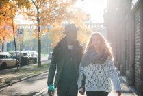 Couple walking on pavement outdoors at daytime — Stock Photo