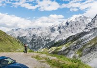 Rear view of woman photographing mountain, Passo di Stelvio, Stelvio, Italy — Stock Photo