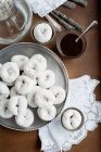 Top view of tray of white donuts with coffee — Stock Photo