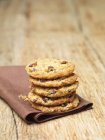 Stack of homemade cookies on tea towel — Stock Photo