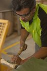 Charpentier tournant le bois avec ciseau en atelier — Photo de stock