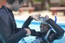 Инструктор по подводному плаванию с ученицей в бассейне — стоковое фото