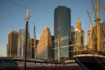 Manhattan buildings with masts of ships, New York City — Stock Photo