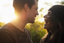 Portrait of couple in autumn sunlight laughing — Stock Photo