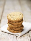 Stack of crumble cookies on tea towel — Stock Photo