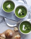 Still life of broccoli soup bowls with sour cream — Stock Photo