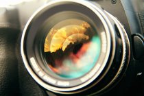 Sunset clouds reflected in camera lens, close up shot — Stock Photo