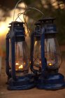 Three retro lanterns on sand, close up — Stock Photo