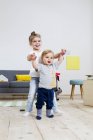 Brother and sister playing at home — Stock Photo