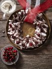Chocolate meringue wreath with cherries — Stock Photo