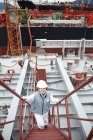 Portrait of worker on steps at shipping port, elevated view, GoSeong-gun, South Korea — Stock Photo
