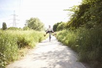 Happy Cyclist cycling on path — Stock Photo