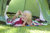 Portrait of girl daydreaming in garden tent — Stock Photo