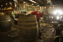 Hombre adulto medio haciendo barril de whisky en la cantera - foto de stock