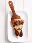 Slice of pizza on platter — Stock Photo