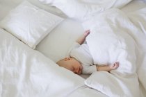 Baby girl asleep in bed — Stock Photo