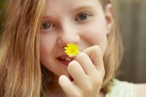 Close up retrato de menina segurando flor de dente de leão — Fotografia de Stock