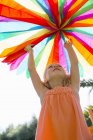 Girl putting up decoration at birthday party — Stock Photo