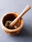 Pestle and mortar with crushed garlic — Stock Photo