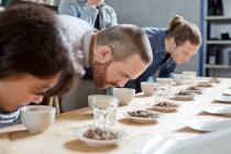 Coffee tasters smelling cups of coffee — Stock Photo