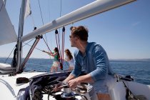 Team setting sail on yacht — Stock Photo