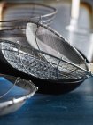 Metal sieves and strainers on table — Stock Photo