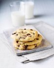 Stack of chocolate chip cookies with glass of milk — Stock Photo