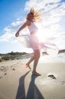 Woman dancing on beach — Stock Photo
