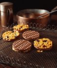 Chocolate coated florentine biscuits on cooling rack — Stock Photo