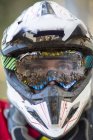 Close up portrait of male motocross racer wearing muddy helmet and goggles — Stock Photo