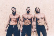 Portrait of three macho male cross trainers in gym — Stock Photo