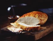 Roasted turkey breast on wooden chopping board — Stock Photo