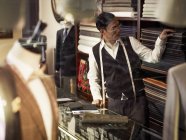 Tailor choosing fabric in traditional tailors shop — Stock Photo