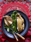 Still life of Beggars Chicken with lotus leaf and greens — Stock Photo