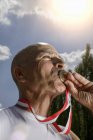 Portrait of Sportsman kissing medal — Stock Photo