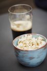 Bowl of pop corn and pint of beer — Stock Photo