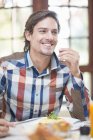Mid adult man sitting at restaurant table — Stock Photo