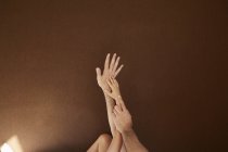 Child and man hands on each other on color background — Stock Photo