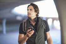 Mid adult man navigating with smartphone in city — Stock Photo