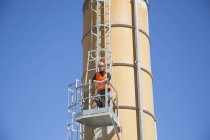 Portrait of worker on smoke stack viewing platform — Stock Photo