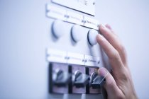 Cropped view of young mans hand adjusting dial on switchgear — Stock Photo