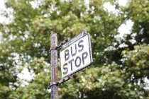 Bus stop sign on road, west yorkshire, United Kingdom — стоковое фото