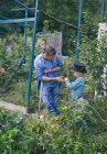 Father and son on green countryside allotment — Stock Photo