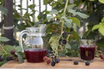 Pitcher and glass of fresh berry juice — Stock Photo