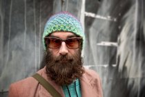 Portrait of bearded mature man with beanie and sunglasses — Stock Photo